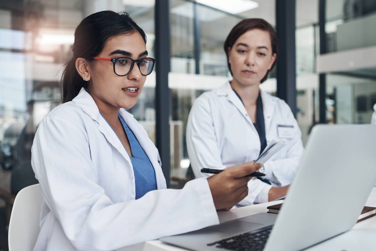 Two healthcare workers discuss the differences between nurse practitioner vs. doctor roles.