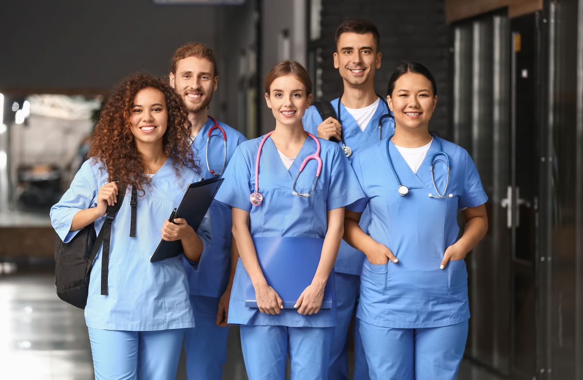 A group of new hires, smiling because they just signed generous nurse sign-on bonuses.