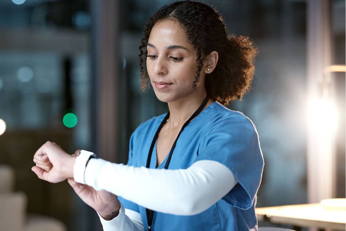 A nurse uses her nurse's watch.
