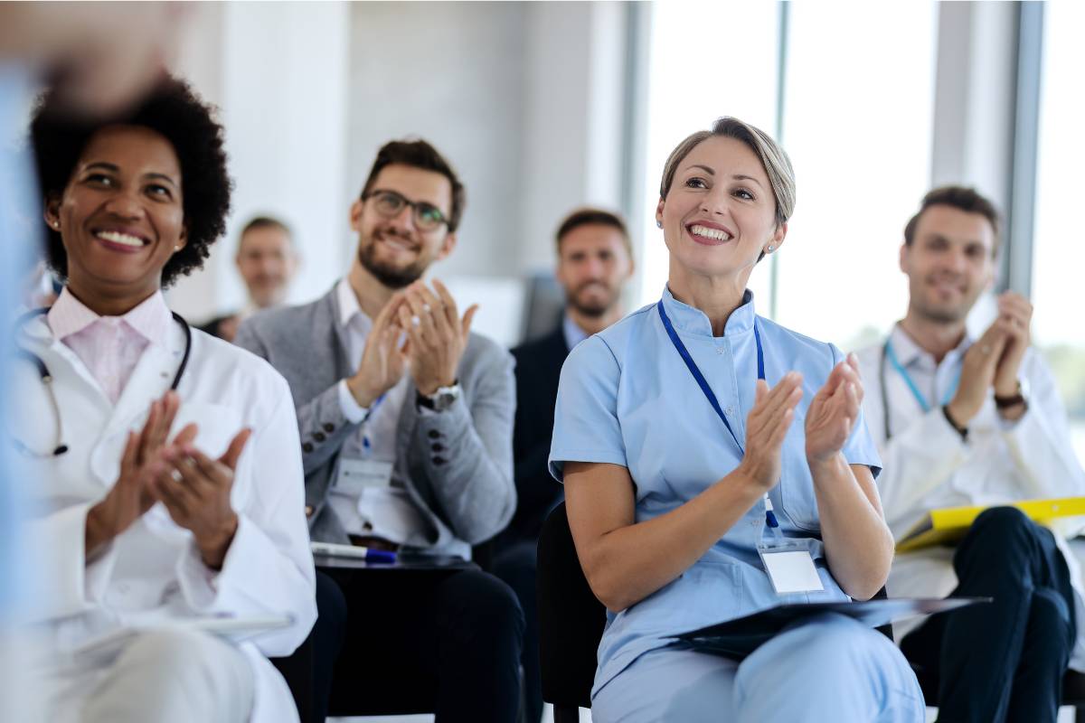 A group of healthcare professionals meet to discuss Nurses Week ideas to celebrate.