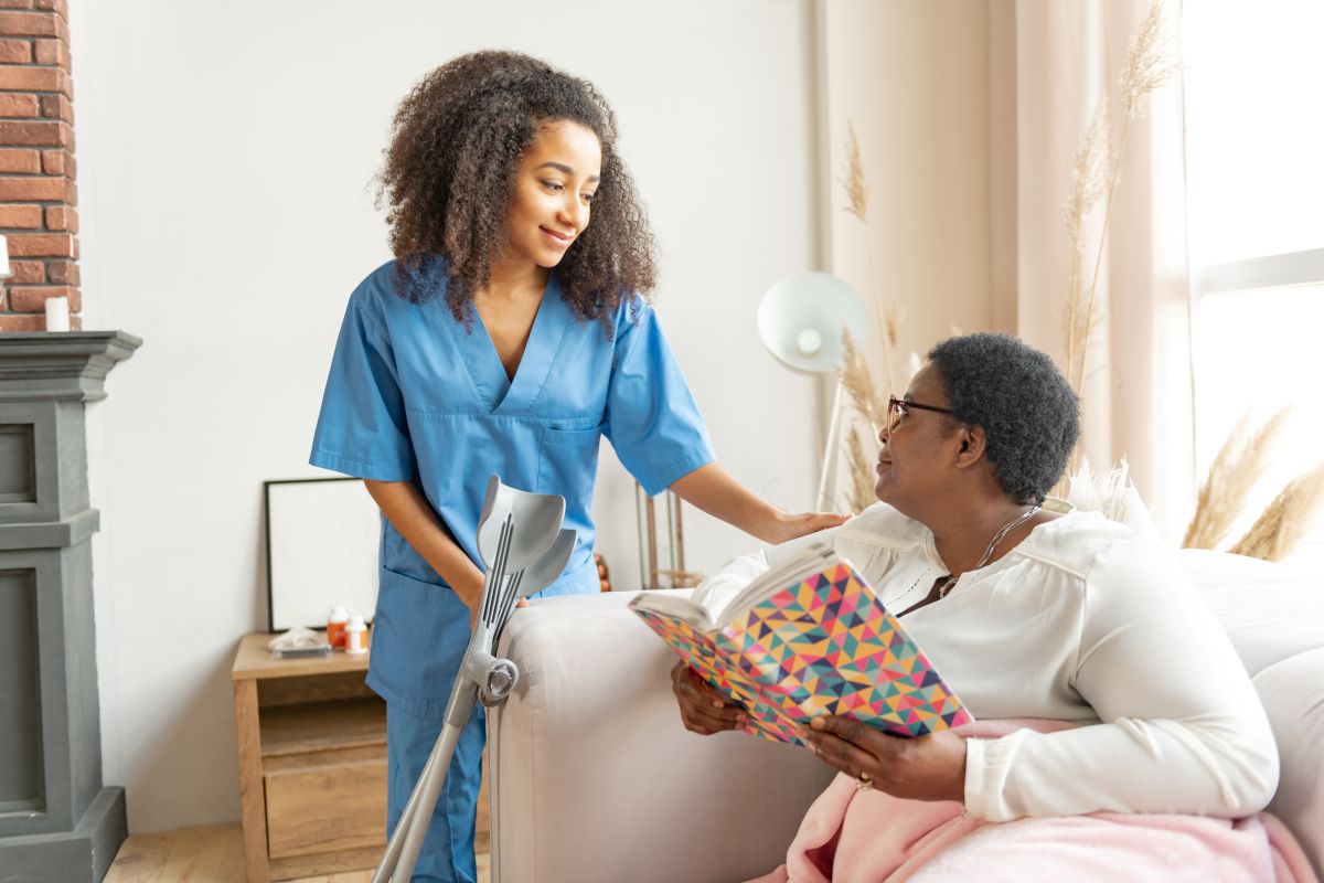 A certified nursing assistant checks on one of the residents at her long-term care facility.