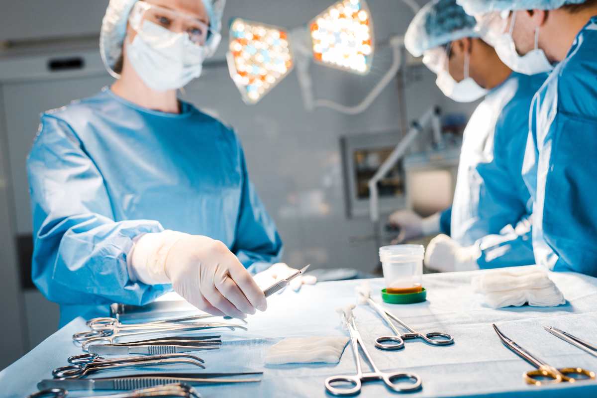 Operating room nurse handling surgical tools