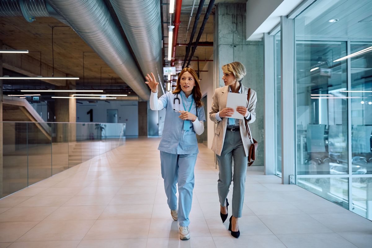 A patient flow coordinator discusses design plans with a hospital executive.