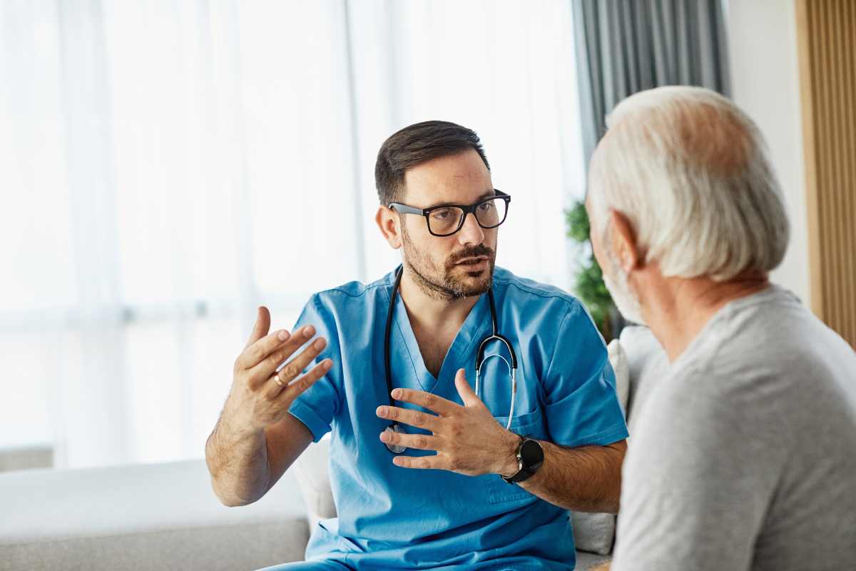 Psychiatric nurse gesturing with hands while explaining something to a patient