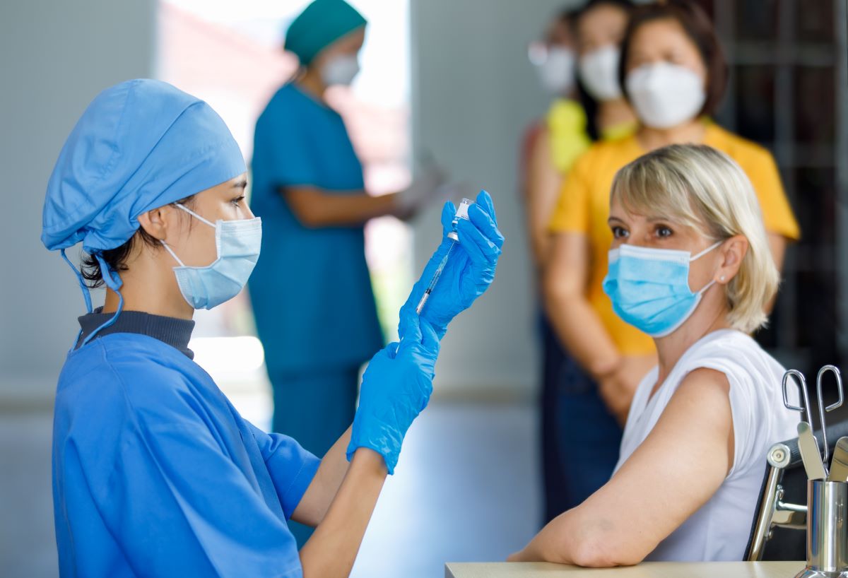A public health nurse administers immunizations at a public clinic.