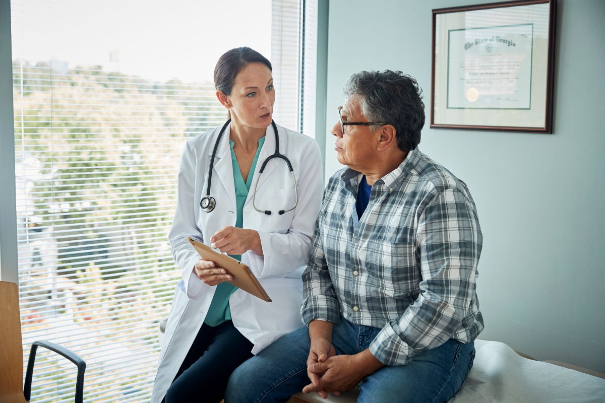A physician talks with one of her patients.