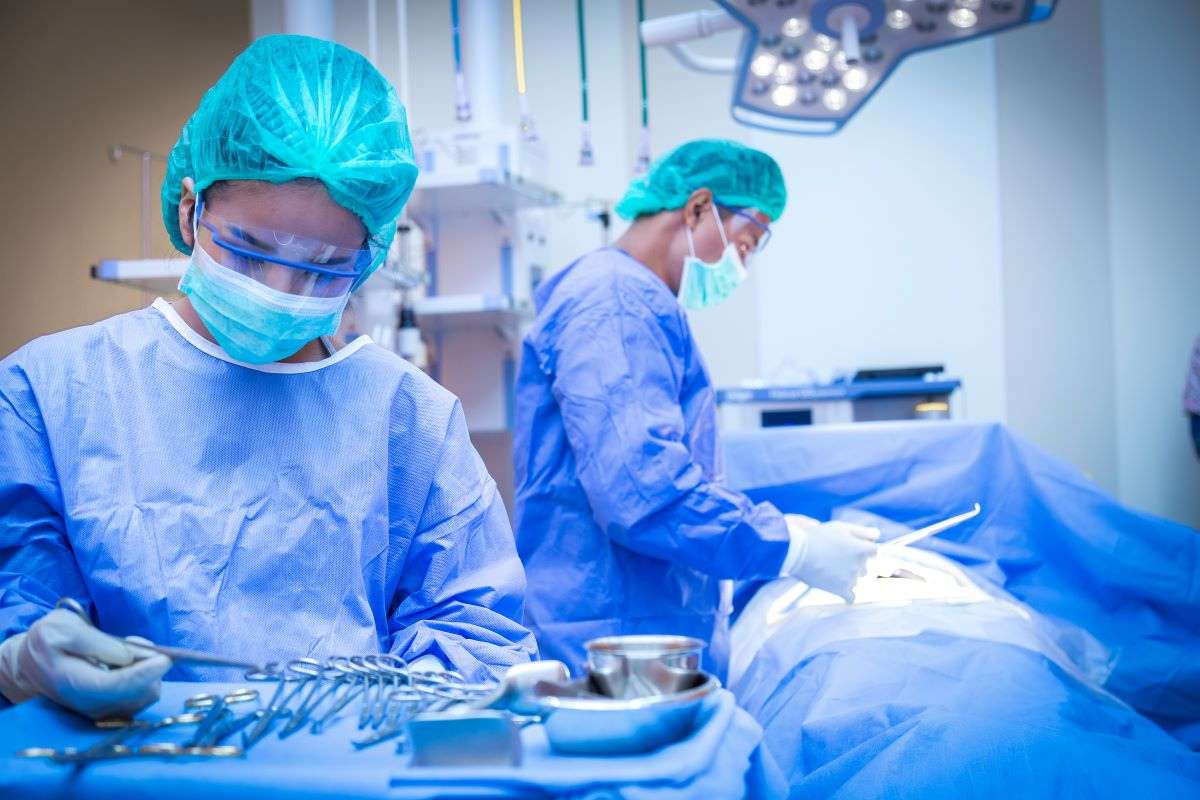 Scrub nurse helping surgical team during a procedure at a hospital