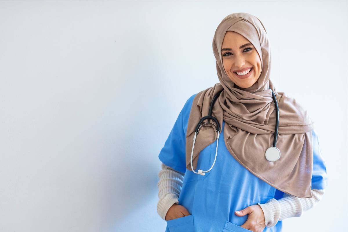 A nurse poses for a photo while discussing the perks of being a nurse.