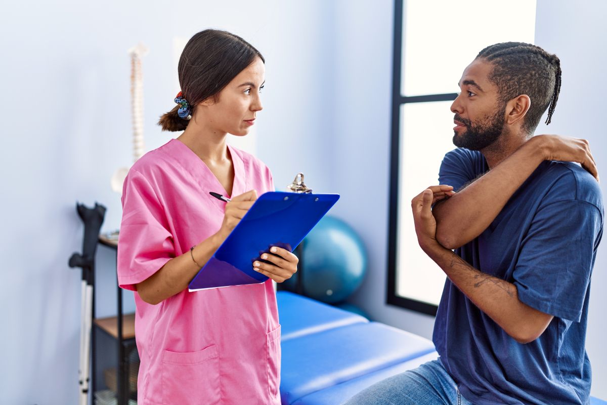 A nurse checks on a patient at a trauma center.