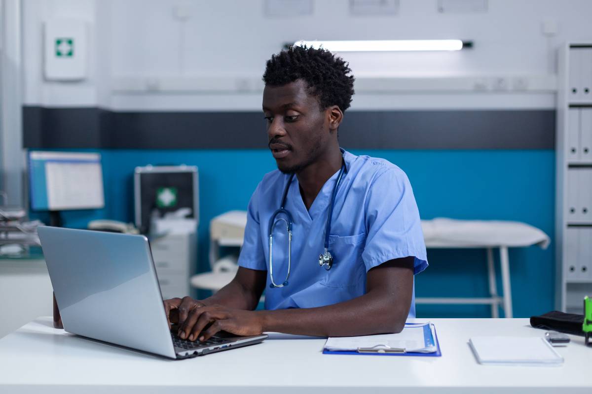 A utilization review nurse completes paperwork.